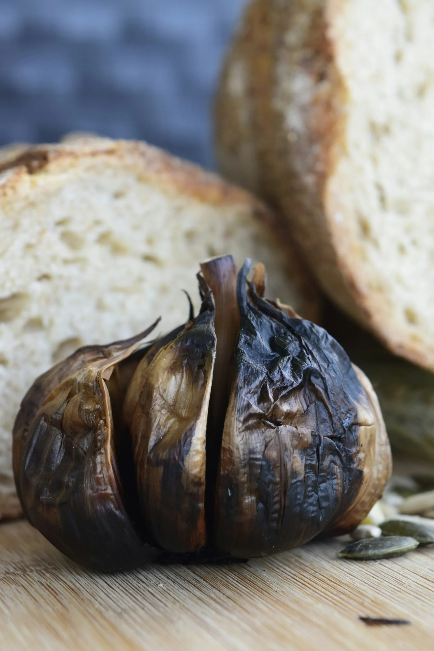 A split bulb of aged black garlic showing the dark cloves